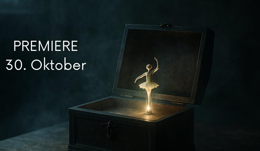 En åpen mørk eske med en glødende ballerina