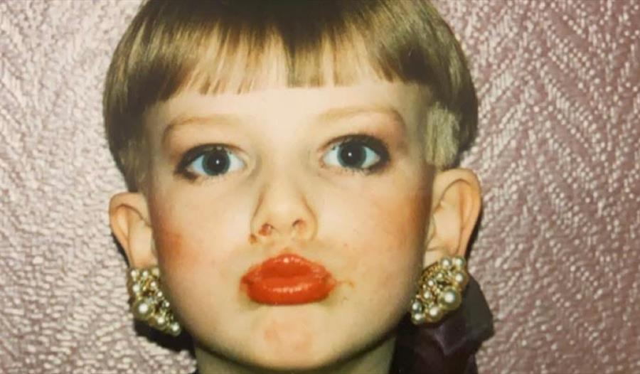 Gutt med øredobber og sminke