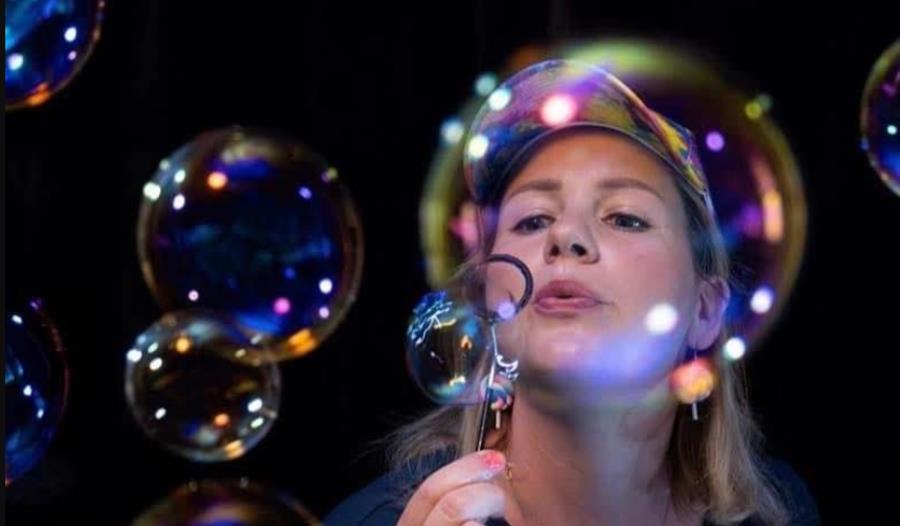 Woman blowing soap bubbles
