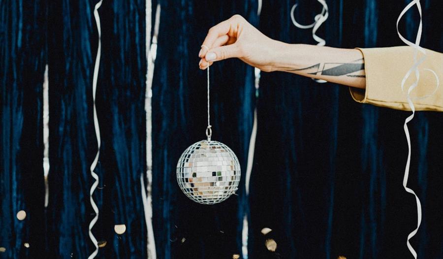 Hand holding Christmas bauble or disco ball
