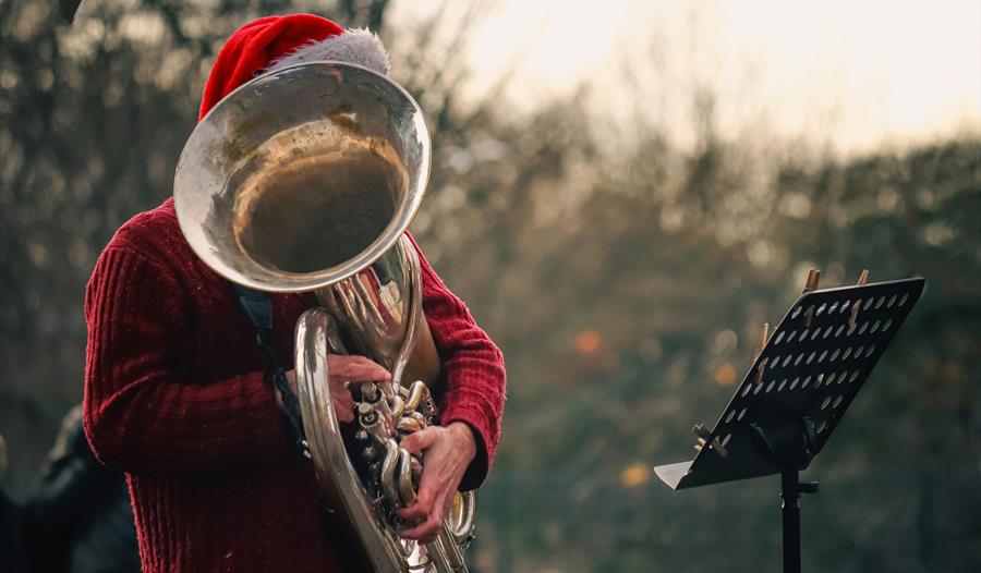 Man Playing on Tuba Outdoors