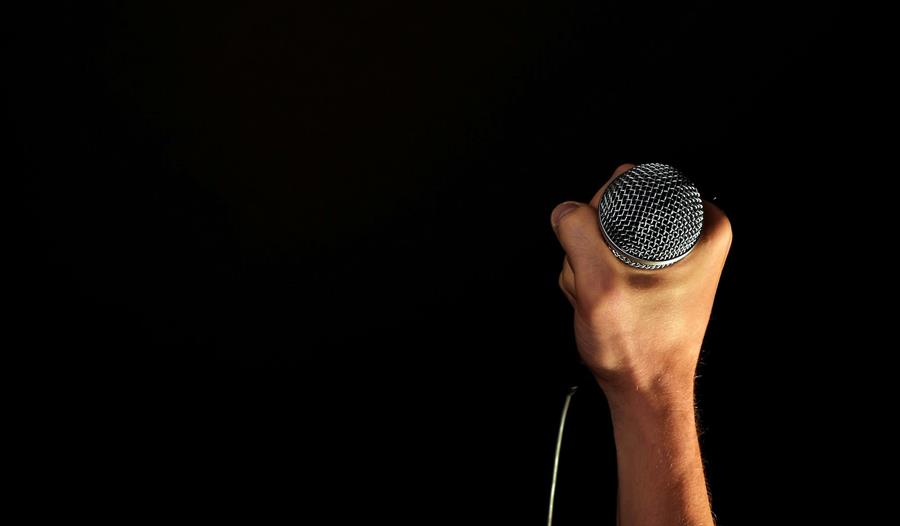 Hand holding microphone
