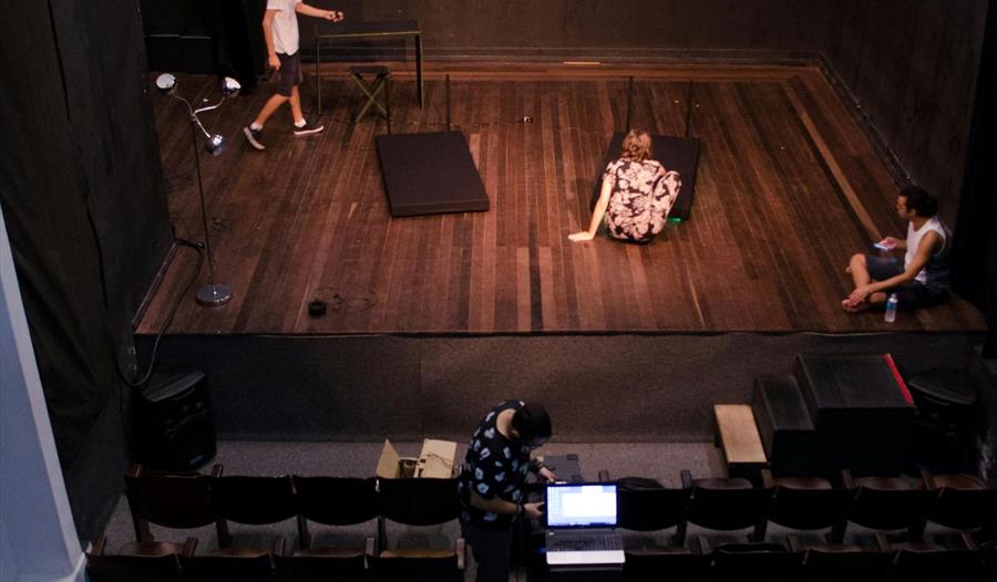 Man Standing on Stage