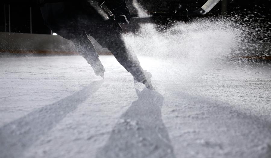 A Person Ice Skating on Ice Rink