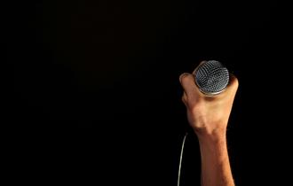 Hand holding microphone