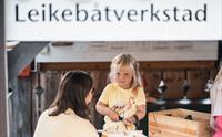 Barn som leikar på leikebåtverkstaden på Hardanger Fartøyvernsenter.