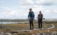 To menn på tur på tresti på Hardangervidda.