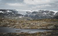 Et fjellvann i forgrunnen, Hardangerjøkulen sett i bakgrunnen.