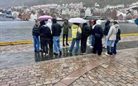 Visiting students take in Bergen in its elements. Strandkaien.
