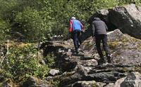 2 personar på veg opp fjellet